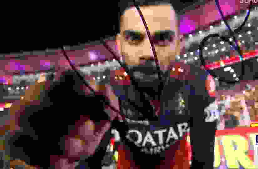 Virat Kohli signs the camera after winning IPL 2025 Final